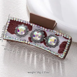 Detail view showing hair claw dimensions of 10.5cm length with sunflower rhinestones