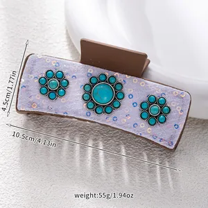 Detail of bohemian large hair claw clip with turquoise flowers and purple sequins