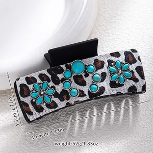 Detail of leopard print hair claw clip with turquoise beads and size dimensions
