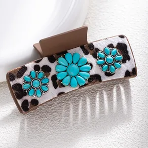 Detail of leopard print hair claw clip with turquoise sunflower stone embellishments