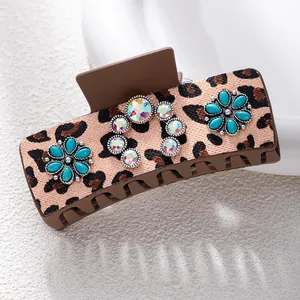 Detail of bohemian leopard print hair claw clip with turquoise and colorful rhinestones