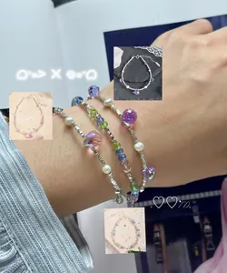 Detail of S925 silver beaded bracelets with colorful crystals and pearls on wrist