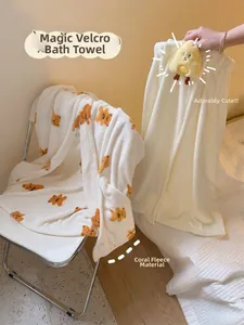Detail of coral fleece wearable bath towel with bear print and chick doll decoration