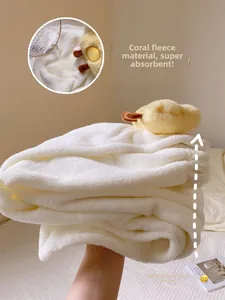 Close-up of thick coral fleece bath towel showing high water absorption and duck decor