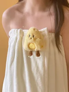 Detail of soft white coral fleece bath towel dress with cute yellow chick doll and elastic top
