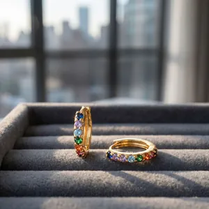 Close-up of 18K gold plated huggie earrings with colorful round cut zircon stones