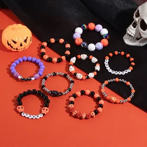Set of 9 Halloween stretch bracelets with orange and black beads, skulls and spooky text
