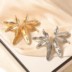 Retro maple leaf stud earrings in gold and silver finish with hammered metal texture