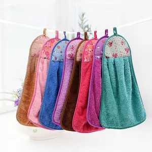 Detail of coral velvet hanging hand towels in seven colors with various patterns