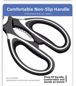 Detail of ergonomic black and white non-slip PP handle and serrated nutcracker on kitchen shears