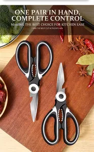 Close-up of multifunctional stainless steel kitchen scissors on a wooden cutting board