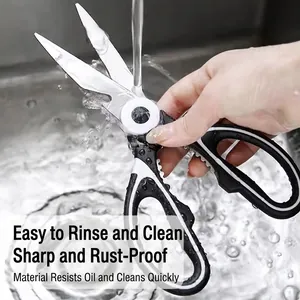 Multi-purpose stainless steel kitchen shears being washed under running water