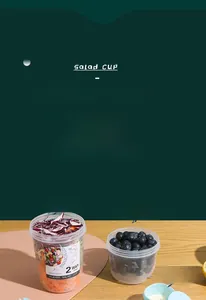 Detail of 500ml+300ml salad cup with dry-wet separation and blue lid on wooden desk