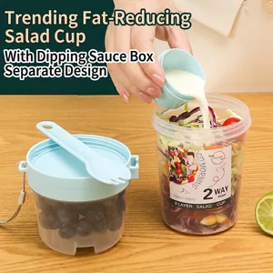 Portable 2-layer salad cup set with 800ml capacity and blue fork spoon on wood background
