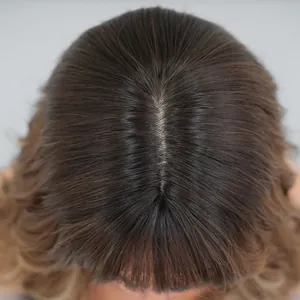 Detailed top view of natural-looking bionic scalp on gradient brown wavy wig with bangs
