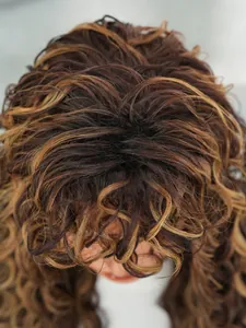 Top macro view showing detailed texture and honey blonde highlights of synthetic curly hair