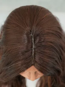 Detail of honey brown wig showing realistic middle part parting and synthetic scalp texture