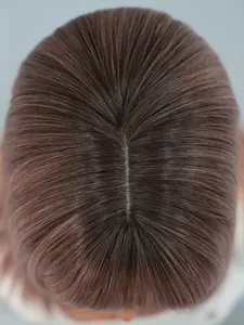 Macro view of a realistic simulated scalp and red-brown wig hair part detail