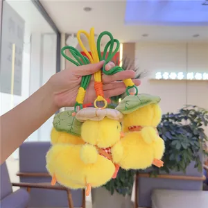 Three cute yellow plush chicks with hats and scarves on colorful woven keychains
