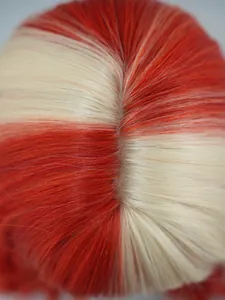 Macro shot of realistic artificial scalp and split seam on red and blonde wavy wig