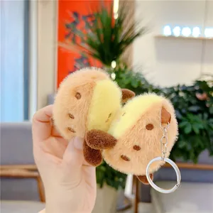 Cute plush sweet potato keychain charm with fluffy texture and silver metal ring