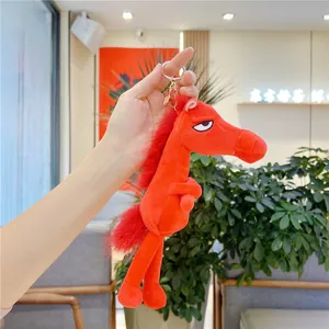 Plush red horse keychain featuring a unique personality face and golden metal hook