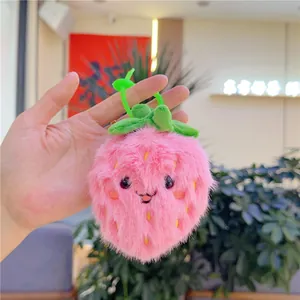 Cute pink strawberry plush keychain with soft fluffy texture and green plastic hook
