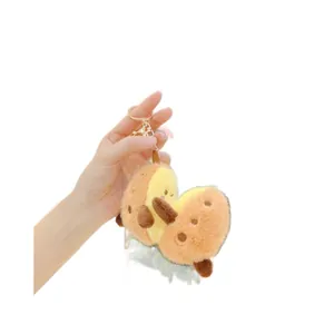 Cute cartoon sweet potato plush keychain with a smiling face and golden metal ring