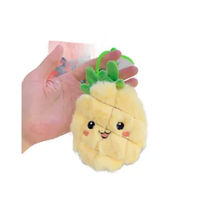 Plush yellow pineapple keychain with green leaves and cute embroidered facial features