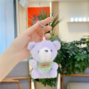 Detail of purple plush bear keychain with green polka dot scarf and silver ring