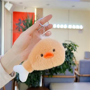 Dettaglio portachiavi in peluche a forma di zampa d'anatra con soffice pelliccia arancione