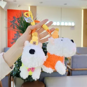 Detail of cute Westie plush keychains featuring knitted hats and colorful sweaters