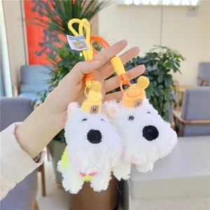 Cute white Westie plush keychains featuring vibrant yellow and orange knitted hats