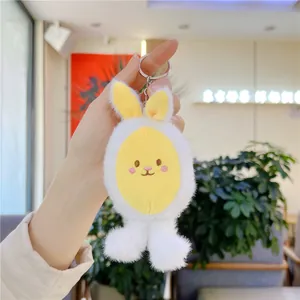 Cute plush bunny keychain with white faux fur and detailed embroidery on a soft background