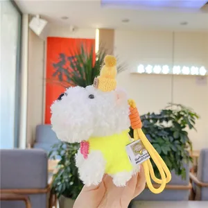 Detail of Westie plush keychain in yellow knitted vest and hat with rabbit patch