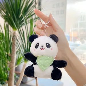 Close-up of plush panda keychain with green polka dot scarf and metal ring