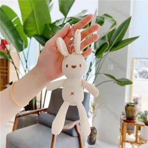 Close-up of a cream canvas bunny plush keychain with a heart nose and silver metal clasp