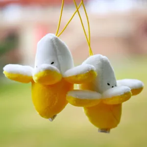 Close-up of cute banana duck plush keychains with yellow peels and white duck faces