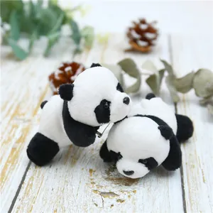 Detail of plush panda brooches with soft texture on a natural wooden background