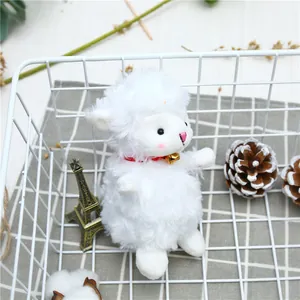 Detail of cute plush lamb doll with red collar and bell sitting in a metal basket
