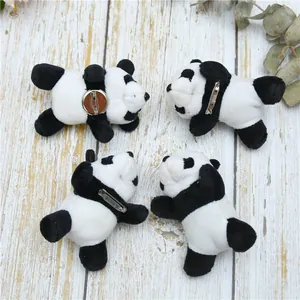 Macro view of plush panda brooches featuring soft fabric and secure metal pins