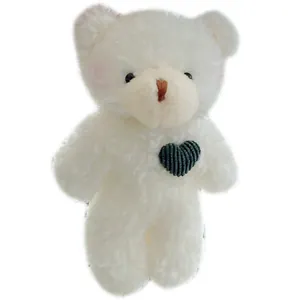 Cute white plush bear doll with green knitted heart and blush cheeks for bags