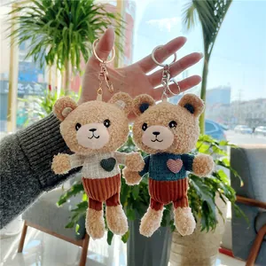 Cute teddy bear plush keychains in blue and white sweaters with heart detail