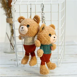 Close-up of cute plush teddy bear keychains with knitted sweaters and corduroy pants