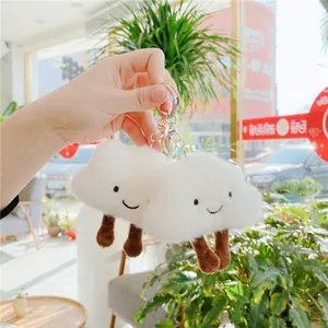 Cute fluffy white cloud plush keychain with smiling face and dangling brown legs