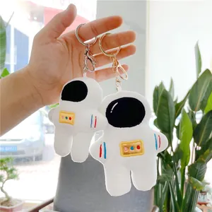 Cute astronaut plush keychain set in white with embroidery details and metal lobster clasp