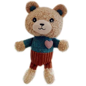 Cute teddy bear plush keychain wearing blue knitted sweater with a pink heart detail