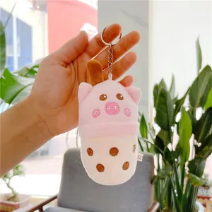Close-up of pink pig bubble tea plush keychain with soft fabric and metal clasp