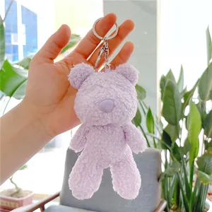 Detail of purple teddy bear plush keychain with soft texture and silver metal clasp