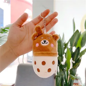 Detailed close-up of a cute plush teddy bear milk tea cup keychain with silver metal ring